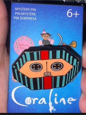 Coraline Mystery Enamel Pin — Black, Teal & Peach Stripe Design